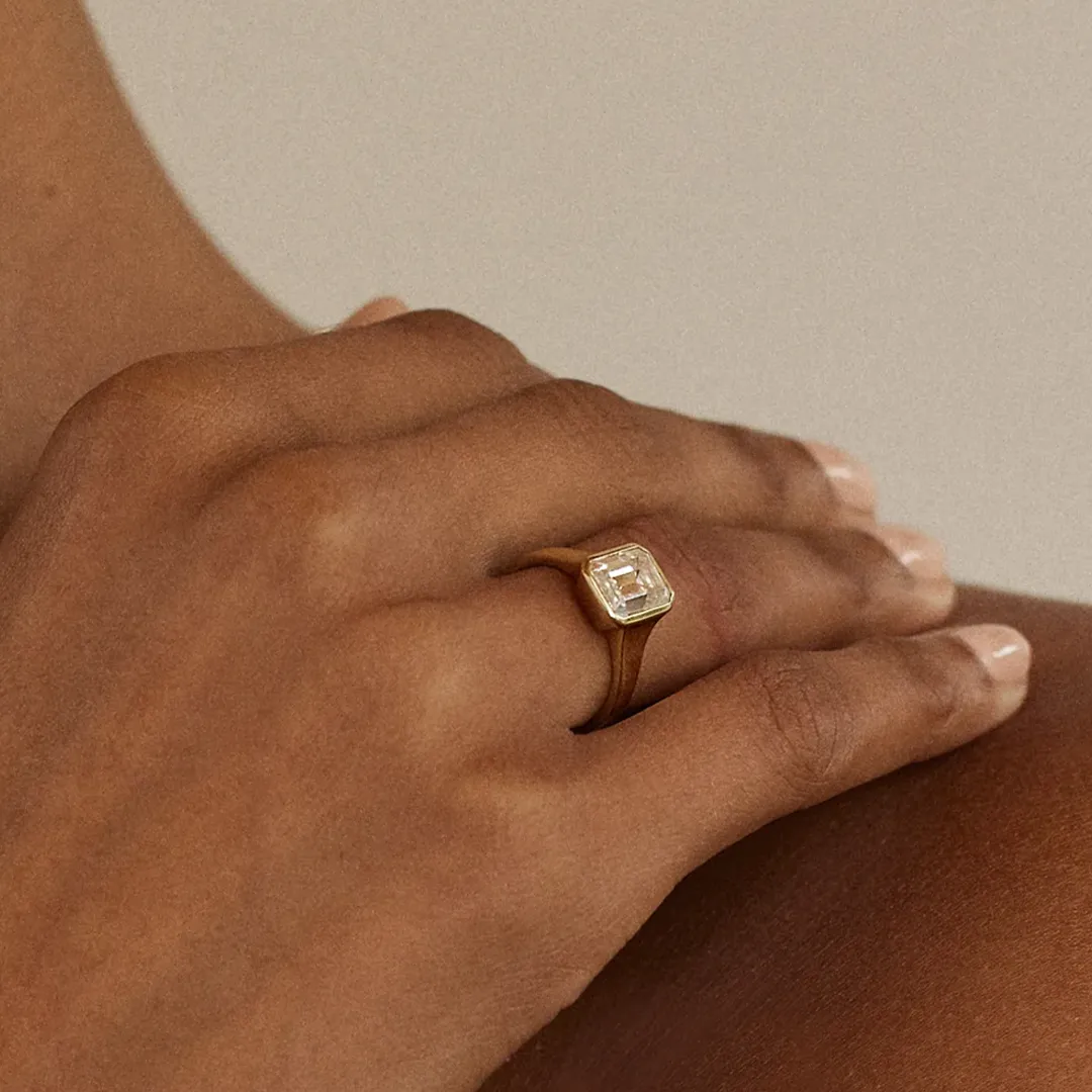 Modern Cosma engagement ring with emerald‑cut diamond bezel set in 18 k rose gold, crafted by hand in Los Angeles