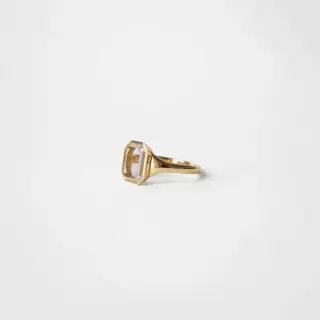 Side profile of the Maren Portrait Bezel Emerald Ring highlighting its sleek, rounded flared band and low setting.