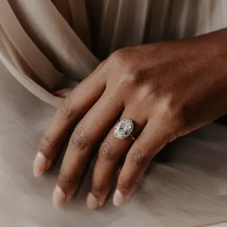 Elegant Nova Oval Ring from Sarah O. Jewelry, showcasing a 1.0ct lab-grown oval diamond surrounded by a ~0.12ctw diamond halo in 14k rose gold.