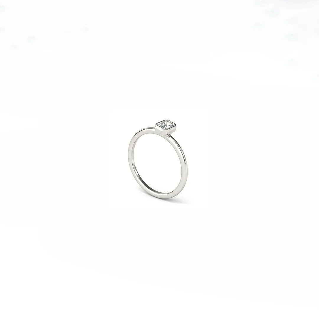 Elegant 0.33 ct lab emerald in bezel setting on a delicate, comfort‑fit rounded white gold stackable ring by Do Amore