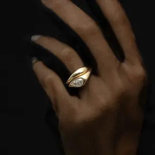 Model wearing the Marlow East-West Pear Ring, emphasizing its bold and modern design.