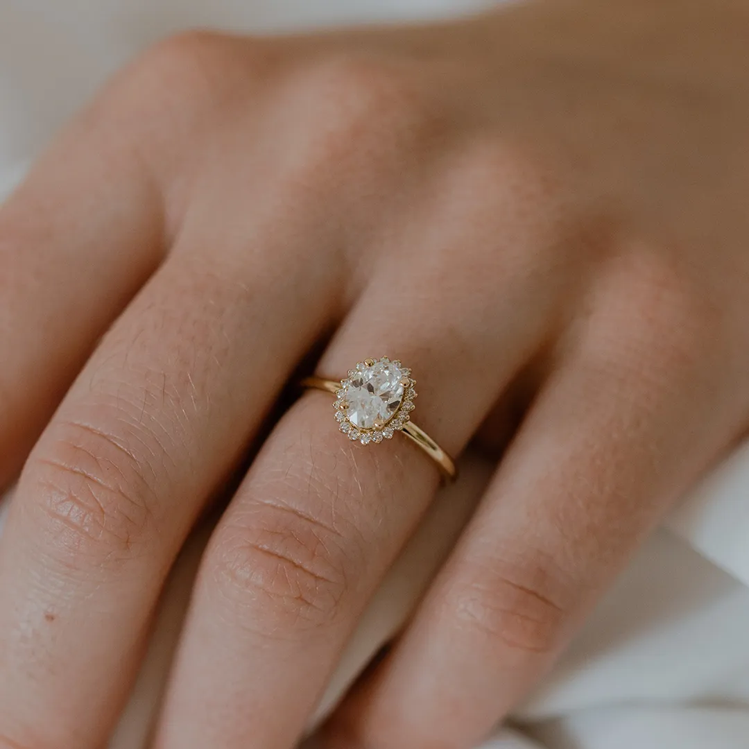 Timeless Nova Oval Ring by Sarah O. Jewelry, set with a 1.0ct lab-grown oval diamond and accented with a diamond halo in 14k rose gold.