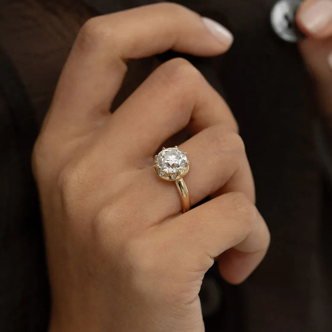 Model wearing the Arden Euro Cut engagement ring on hand, showcasing its bold halo and radiant center stone.