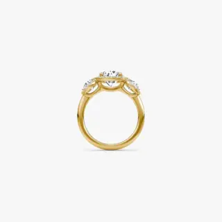 Three‑Stone Halo Ring by VRAI in 18K yellow gold with round brilliant center diamond and trapezoid side stones with pavé halo