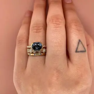 Side view of the Estrada Ring in 14k yellow/white/rose gold, featuring a horizontally oriented 2.31 ct spinel in a sleek half‑bezel design paired with subtle .09 ctw SI G‑H diamond accents along half the band.