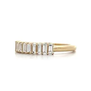 Elegant modern band featuring six .11 ct G‑H color SI1 clarity baguette diamonds totalling .66 ct in yellow gold