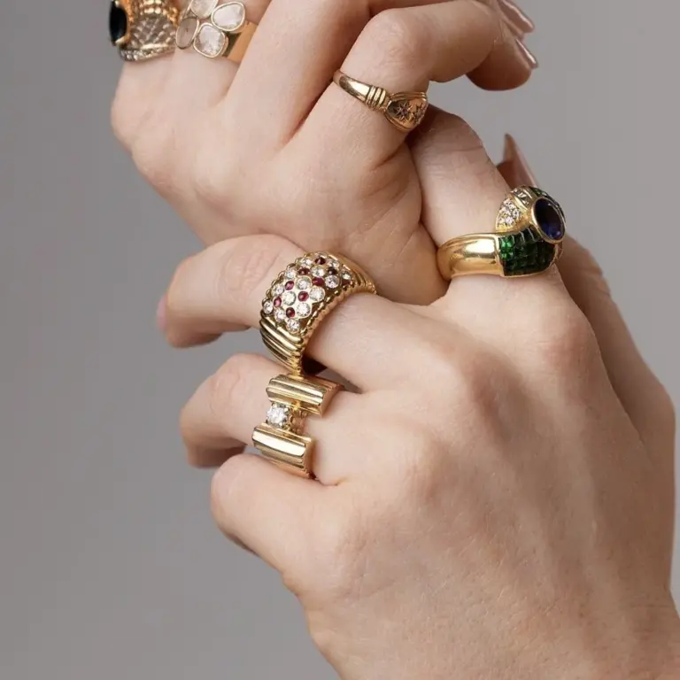 Top-down view of Royal engagement ring featuring Art Deco-inspired harlequin checkerboard pattern of red cabochon rubies and sparkling diamonds in 14K yellow gold.