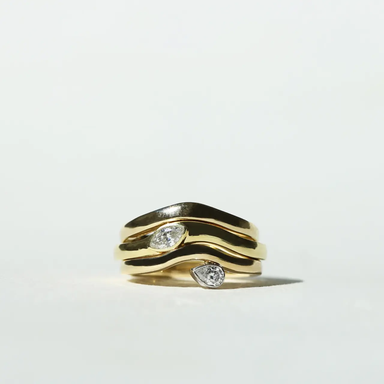 Grace Lee Pear Diamond Wave Band in 18K yellow gold with a pear-cut diamond set at the crest