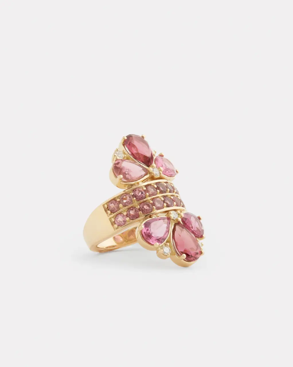 Side profile of 18K yellow gold pear-shaped pink tourmaline ring with diamond accents, emphasizing its sleek silhouette and craftsmanship