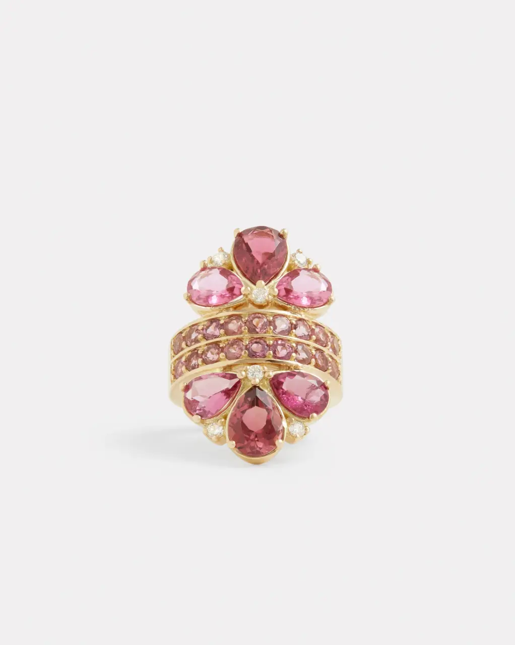 18K yellow gold pear-shaped pink tourmaline and diamond ring displayed on a stand, showcasing its luxurious design and fine details