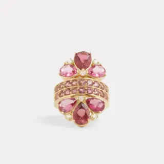 18K yellow gold pear-shaped pink tourmaline and diamond ring displayed on a stand, showcasing its luxurious design and fine details