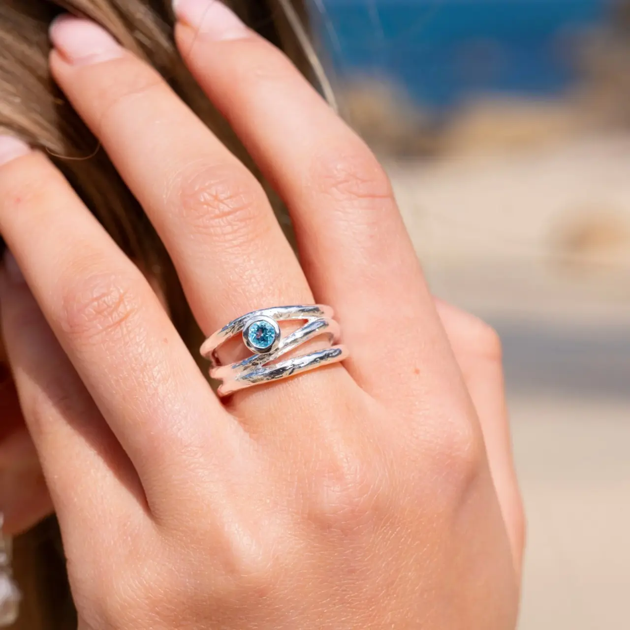 Three‑row Wave ring by Elsa Peretti in yellow gold, with sinuous layered design and central 0.05 ct round brilliant diamond