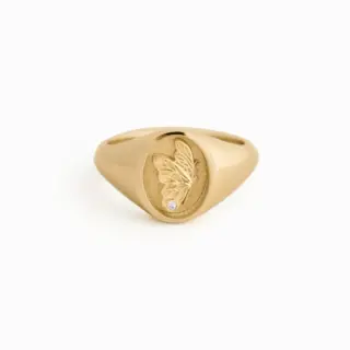 14k solid gold Juliette Butterfly Signet Ring by Kinn Studio featuring a finely textured butterfly wing with a round lab-grown diamond, engraved with 'evolve' inside the band
