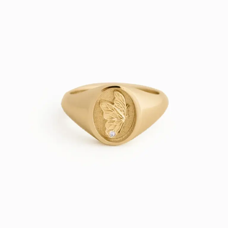 14k solid gold Juliette Butterfly Signet Ring by Kinn Studio featuring a finely textured butterfly wing with a round lab-grown diamond, engraved with 'evolve' inside the band