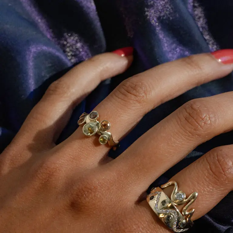 Macro detail of the Cadlina ring’s sapphires, revealing the kaleidoscope effect and grain of the yellow-gold setting.