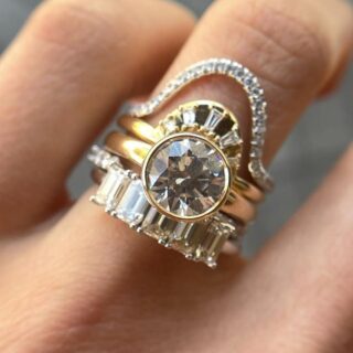 Close-up of the Tessa Bezel Round Solitaire Engagement Ring, highlighting the clean lines of the 14K yellow gold band and the brilliance of the 1.5ct diamond.