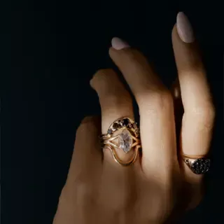 Colette engagement ring: elongated marquise diamond set in bezel on split-shank yellow gold band