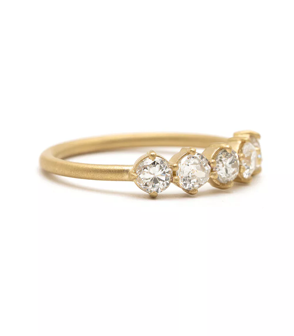 Yellow gold wedding band with five rose‑cut diamonds aligned across the top of the band in a textured finish