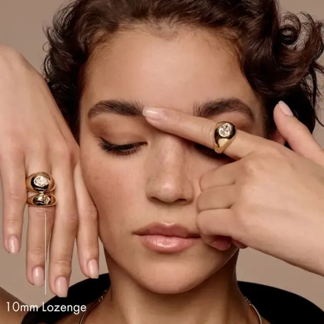 Model wearing the Lozenge Dome Band Ring, emphasizing its sleek and elegant design suitable for stacking or as a standalone piece.