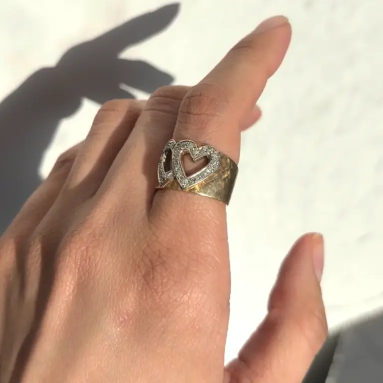 Double heart cigar band on a finger