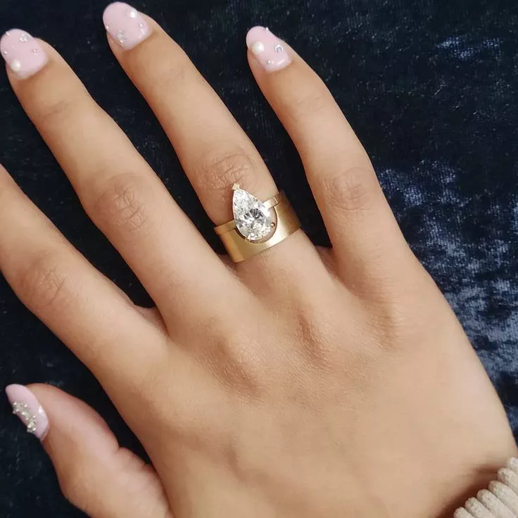 Close-up of the 2.5 ct pear-shaped diamond in the Mid-Century Kahn Pear Ring, highlighting the high-polish finish and architectural inspiration