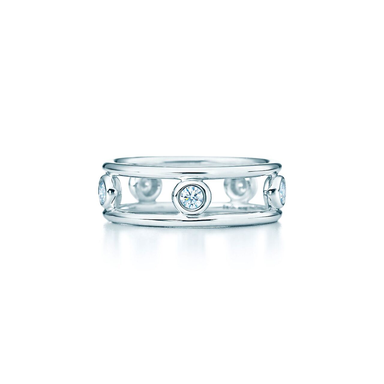 Elegant 18K yellow gold ring with five bezel-set diamonds, part of Tiffany’s Elsa Peretti® Diamonds by the Yard® collection