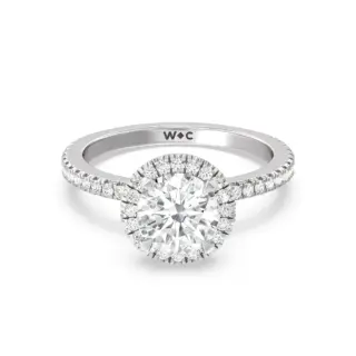 Close-up of lab-grown diamond halo ring showcasing pavé diamonds on the shank and brilliant IGI-certified center stone.