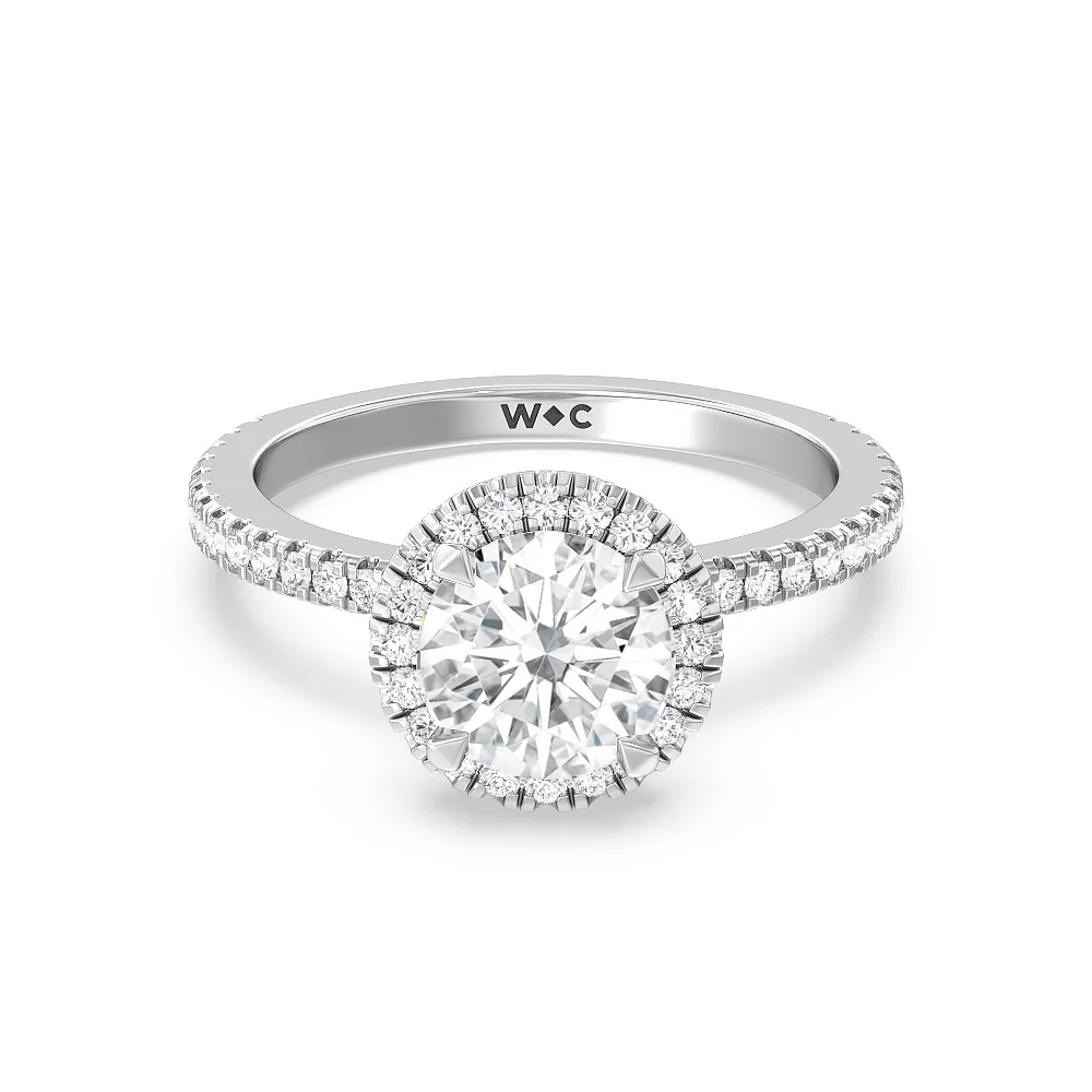 Close-up of lab-grown diamond halo ring showcasing pavé diamonds on the shank and brilliant IGI-certified center stone.