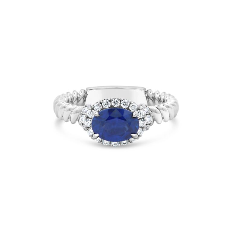 Jack Kelege KGR170S Oval Sapphire and Diamond Ring featuring 1.28ct east-west set oval sapphire and 0.32ct G VS diamonds in 18k white gold.