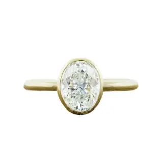 Katie Oval Bezel-Set Solitaire Engagement Ring with oval-cut diamond in a sleek bezel setting, crafted in 14k or 18k gold or platinum.
