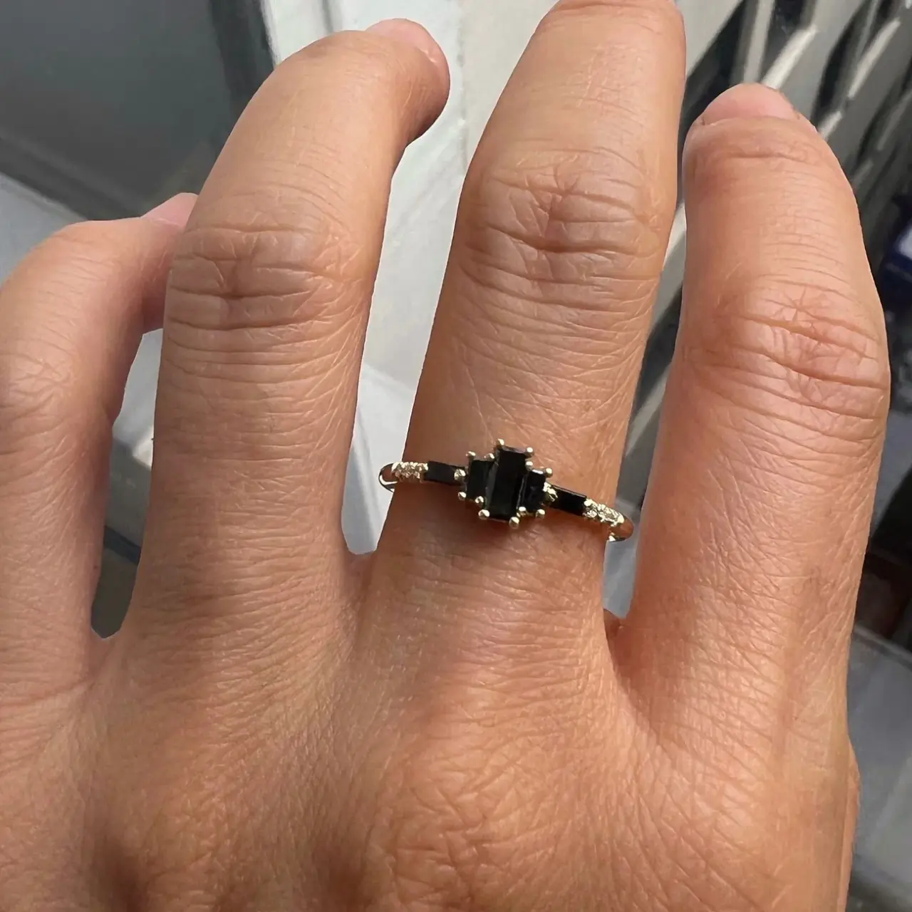 4k gold Marcato Ring by Jennie Kwon, adorned with baguette black diamonds and white diamonds, offering a striking contrast and delicate design.