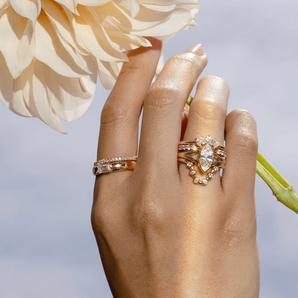4k yellow gold Colette ring featuring a sleek bezel-framed marquise diamond and split shank band