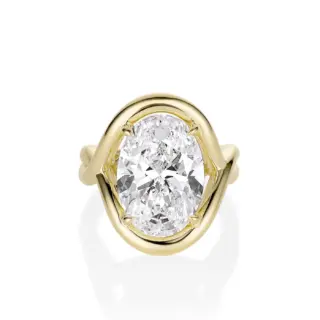 Model wearing the Marrow x Sammi Florence engagement ring, highlighting the oval diamond and flowing serpentine gallery in yellow gold