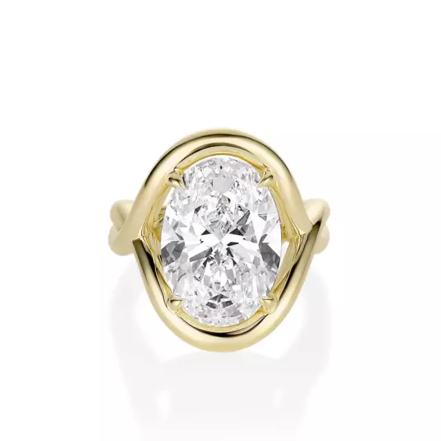 Model wearing the Marrow x Sammi Florence engagement ring, highlighting the oval diamond and flowing serpentine gallery in yellow gold