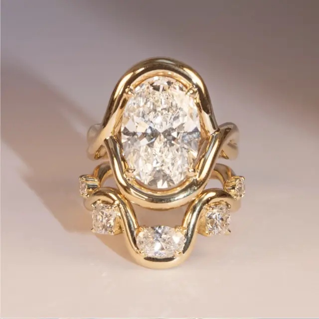 Close-up of the Florence Ring showing the oval lab diamond with serpentine side details in 14k recycled gold