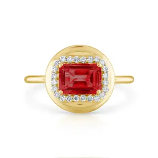 Close-up of Stephanie Gottlieb's Mini Candy Button Ring showcasing a polished 14K yellow gold band with a bold emerald gemstone and diamond accents