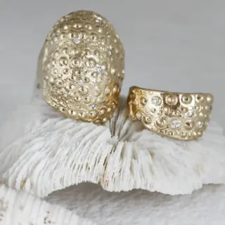Gold sculptural ring with organic shape.