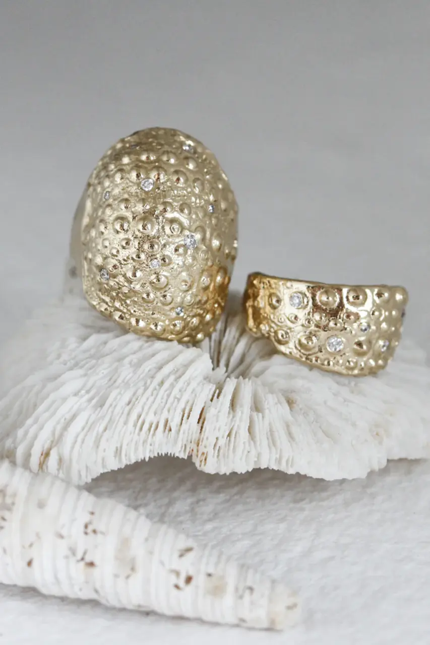 Gold sculptural ring with organic shape.