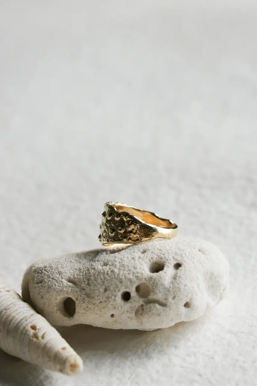 Handmade 14k gold statement ring with botanical-inspired curves and artisanal finish.