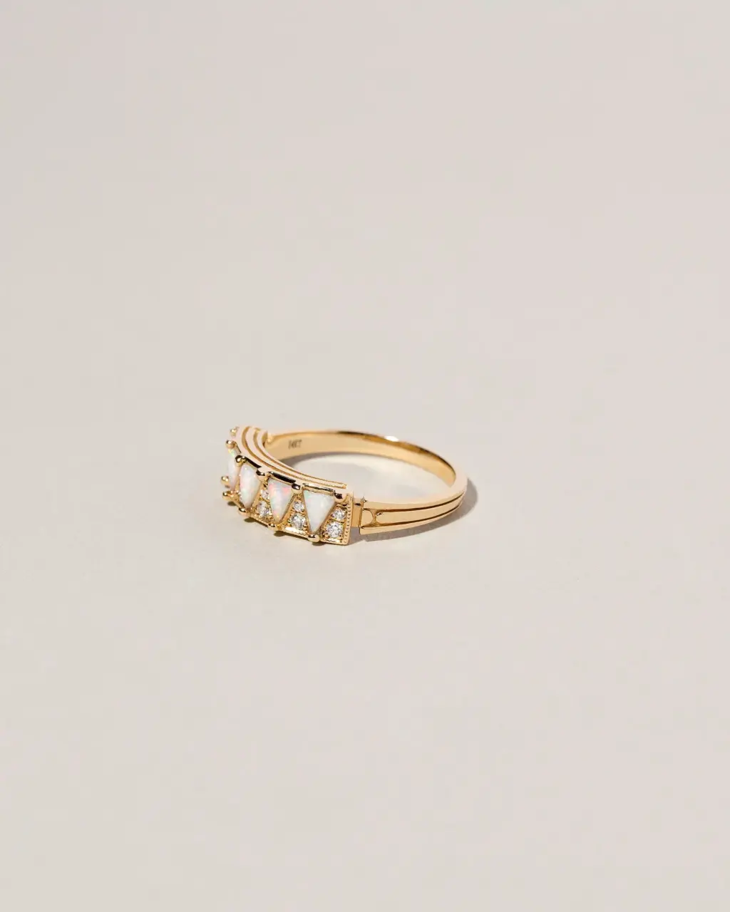 Mociun Five Triangle Ring featuring five triangular white opal cabochons and twelve white diamonds, set in choice of gold.
