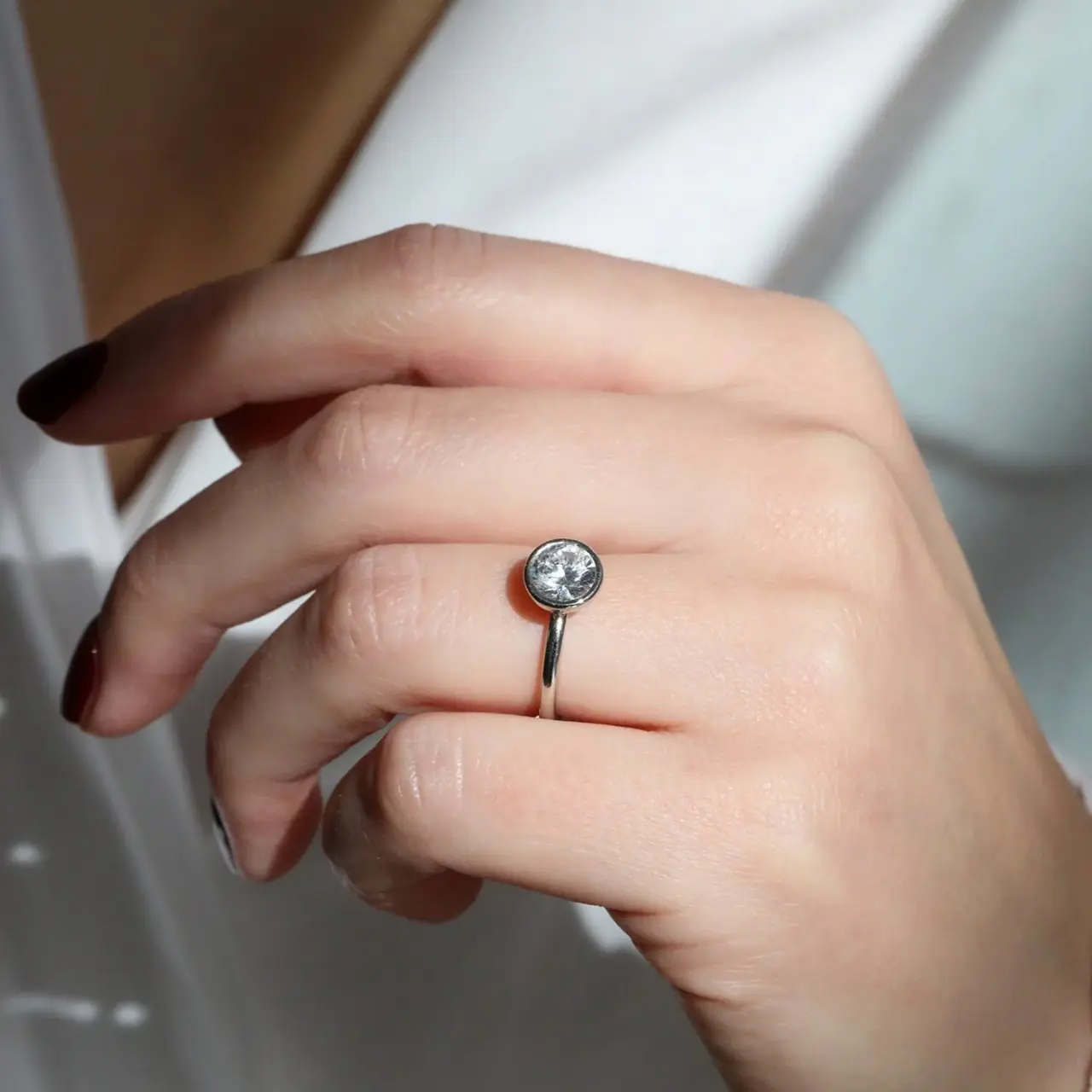 Elegant platinum open-sided bezel ring mount by Mark Patterson, designed to highlight the center stone's brilliance