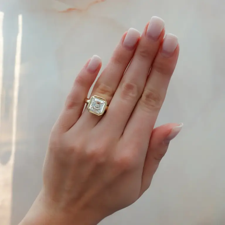 Side profile of Club ring showcasing the chunky tapered shank and bathtub‑style bezel holding the Asscher diamond.