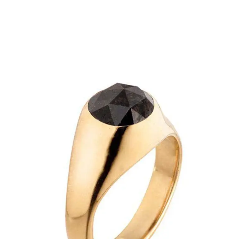 Close-up of the faceted black diamond atop the 18k recycled gold ring, inspired by the volcanic landscapes of Santorini.