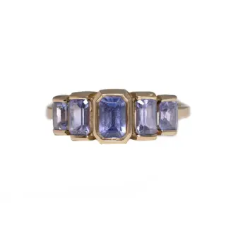 Juno Ring by Oma Jewelry featuring five emerald-cut purple tanzanite stones set in 14k gold, totaling 1.63 carats