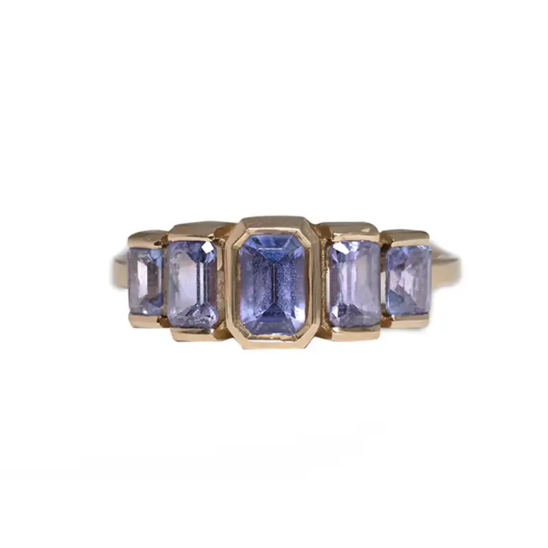 Juno Ring by Oma Jewelry featuring five emerald-cut purple tanzanite stones set in 14k gold, totaling 1.63 carats