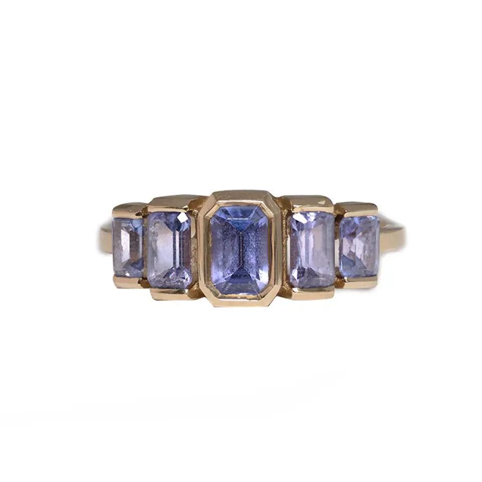 Juno Ring by Oma Jewelry featuring five emerald-cut purple tanzanite stones set in 14k gold, totaling 1.63 carats