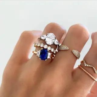 14k yellow gold three-stone engagement ring with oval center stone and pear side diamonds