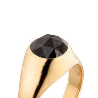 Jane Bartel’s luxe signet ring worn on hand, showcasing the striking contrast between the deep black diamond and warm gold.