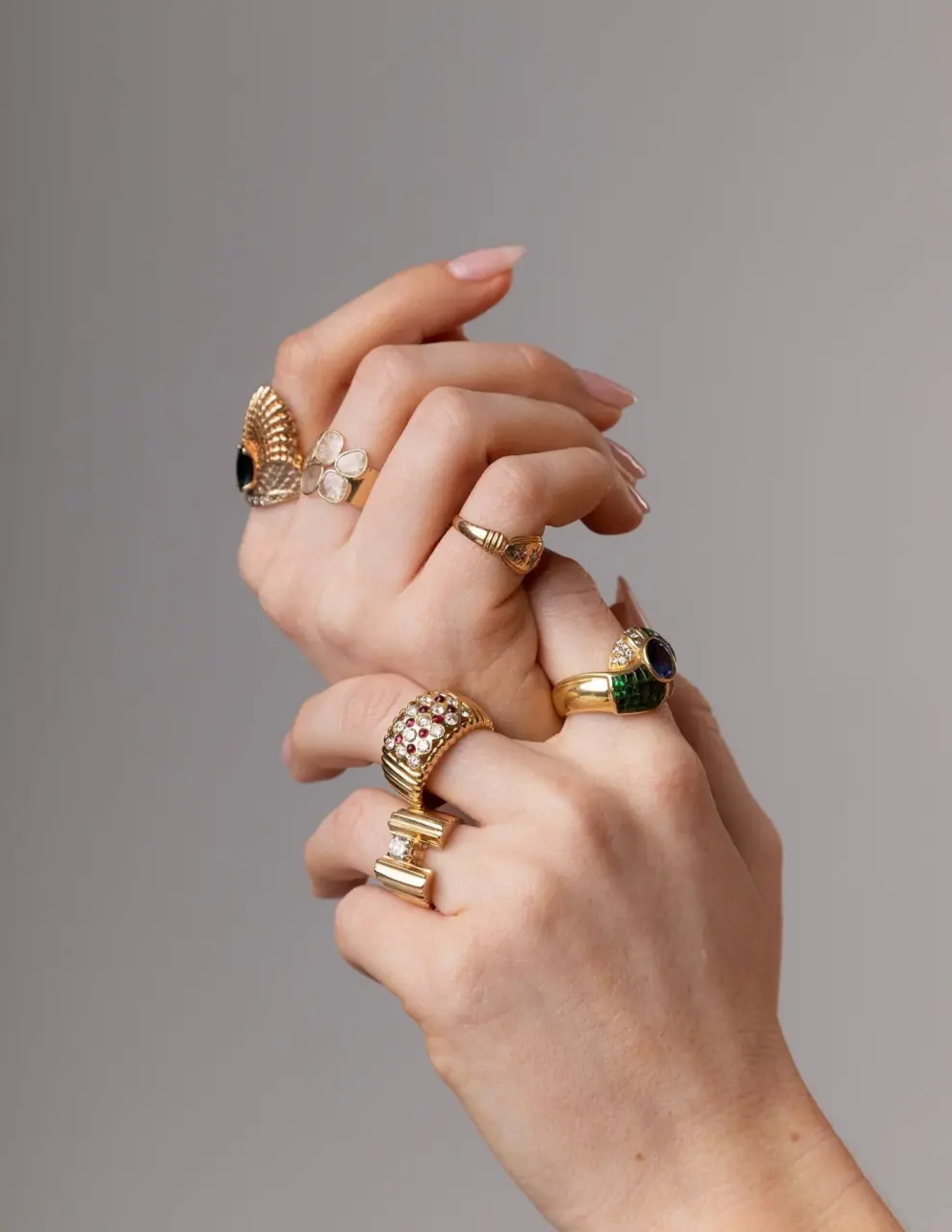 Styled flat-lay of Royal engagement ring in recycled 14K yellow gold, showcasing checkerboard layout of cabochon rubies and brilliant diamonds with vintage Art Deco flair