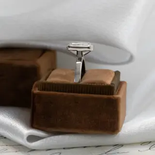 Side view of the Elena Emerald Cut Solitaire Ring highlighting the sleek 2.5 mm band and bezel-set diamond